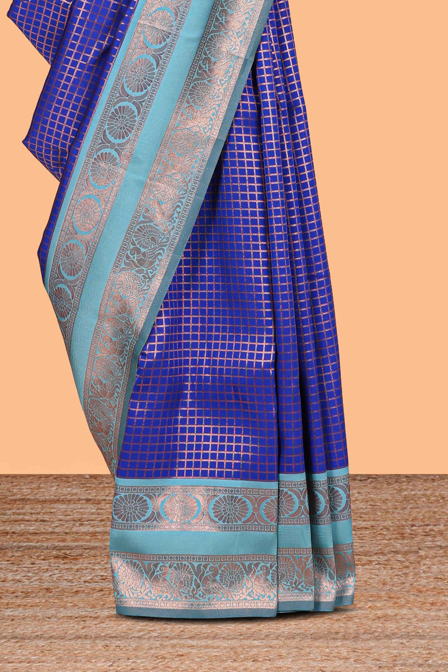 Blue checked semi soft silk saree with contrast zari border and floral motifs blouse