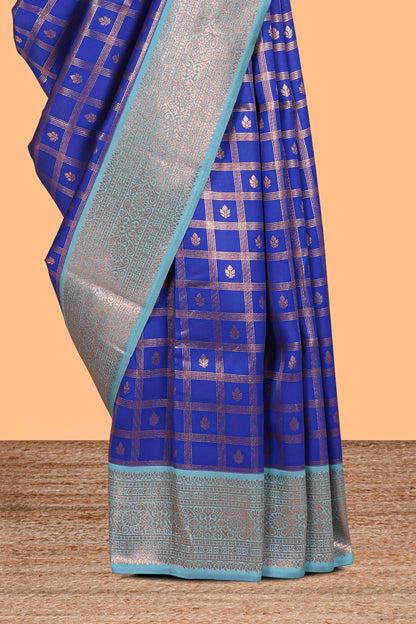 Blue checked floral design motifs semi soft silk saree with contrast zari border and floral motifs blouse