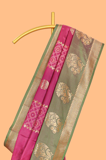 Magenta colour semi soft silk saree with contrast paisely border and contrast zari buttas blouse