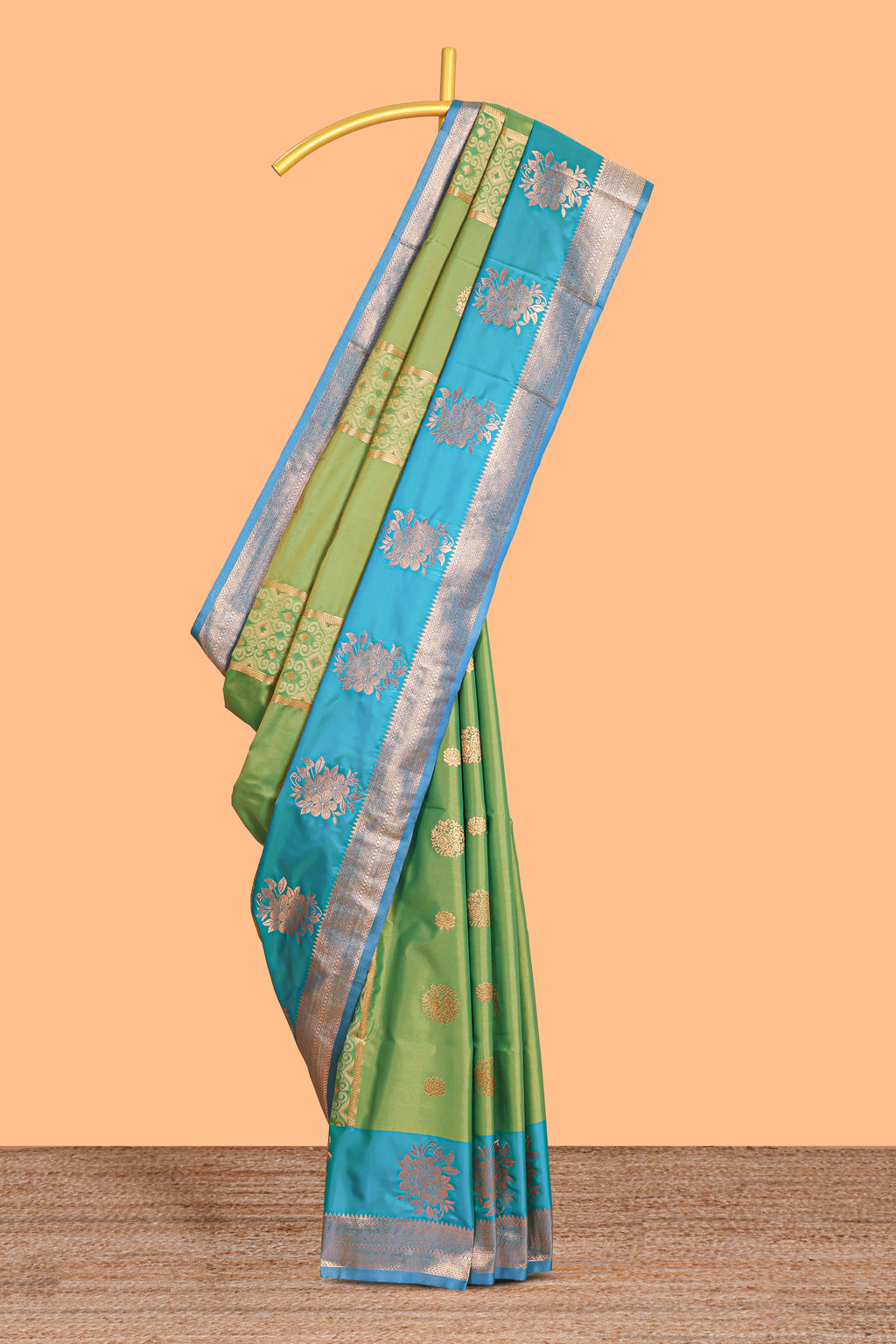 Green Semi soft silk saree  copper  zari motifs with contrast border and pallu with a matching  blouse