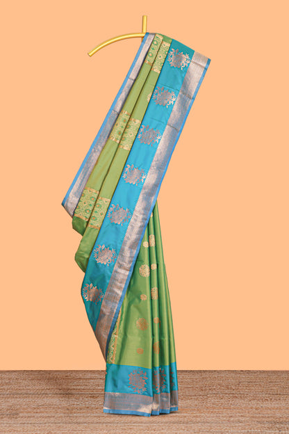 Green Semi soft silk saree  copper  zari motifs with contrast border and pallu with a matching  blouse