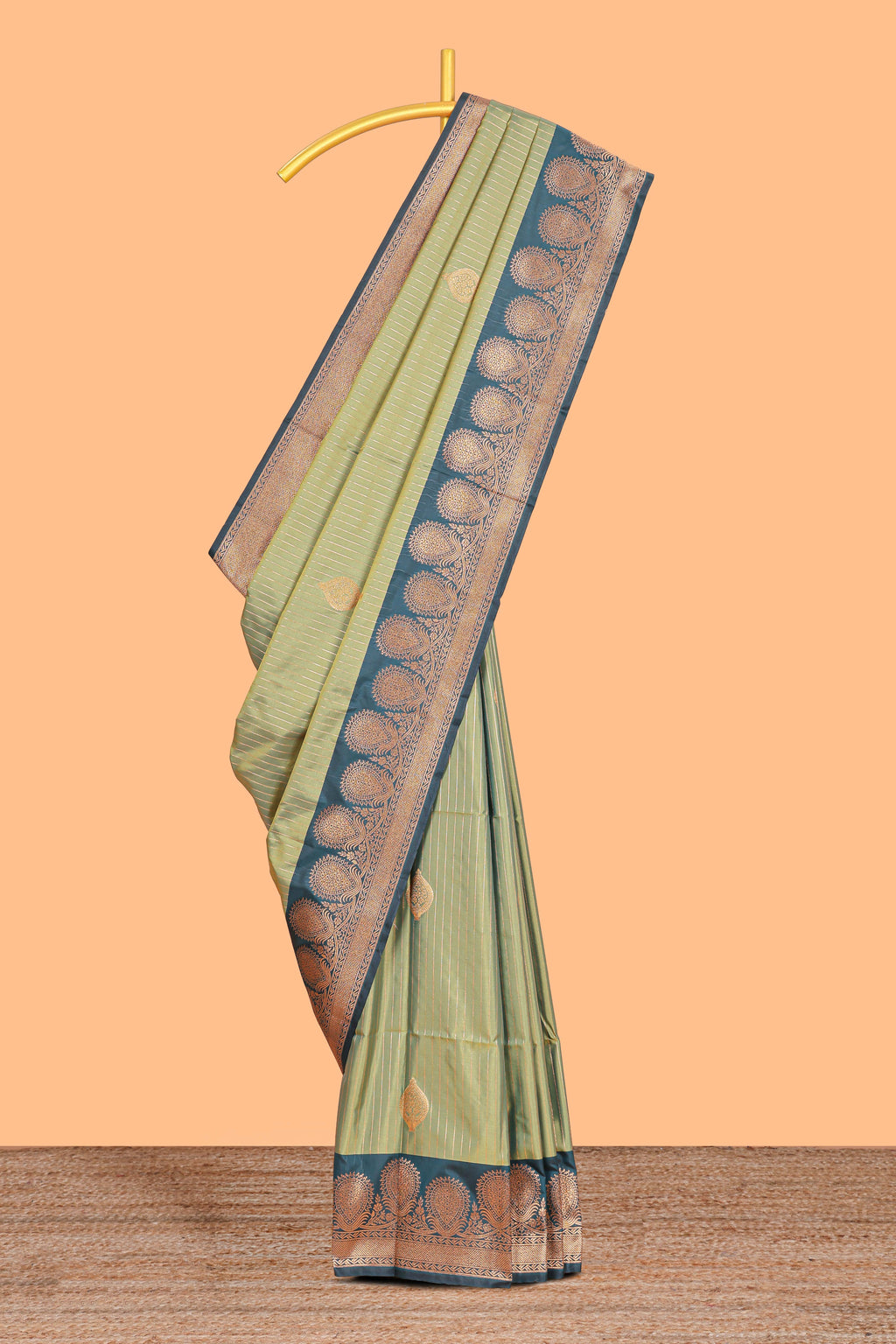 Green colour semi soft silk all over zari striped pattern with contrast zari weaving border and contrast buttas weaving blouse