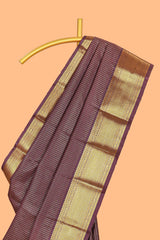 Brown colour semi soft silk all over checked pattern andContrast zari weaving border and Matching blouse
