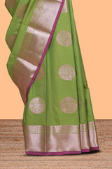 Green zari motifs design semi soft silk saree with contrast zari border and blouse
