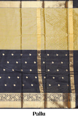 Black floral butta detailed Semi Soft Silk Saree with rich gold floral zari borders along with matching blouse