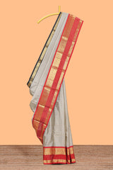 Silver checked semi soft silk saree with contrast zari border and matching striped blouse