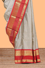Silver checked semi soft silk saree with contrast zari border and matching striped blouse