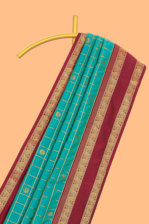 Viridian green checked floral zari motifs design semi soft silk saree with contrast border and blouse