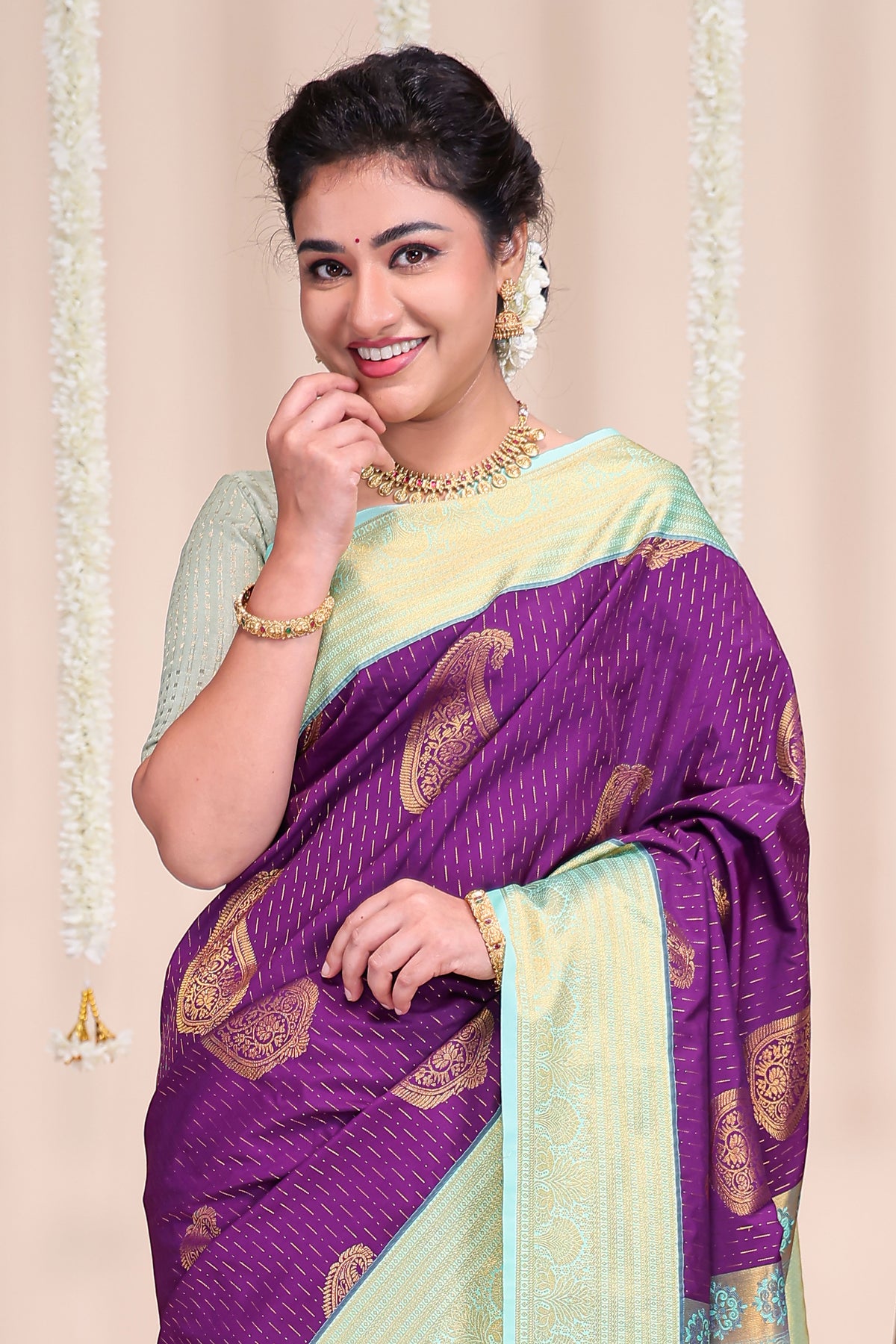 Purple butta designed semi soft silk saree with contrast zari border and contrast blouse