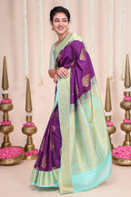Purple butta designed semi soft silk saree with contrast zari border and contrast blouse