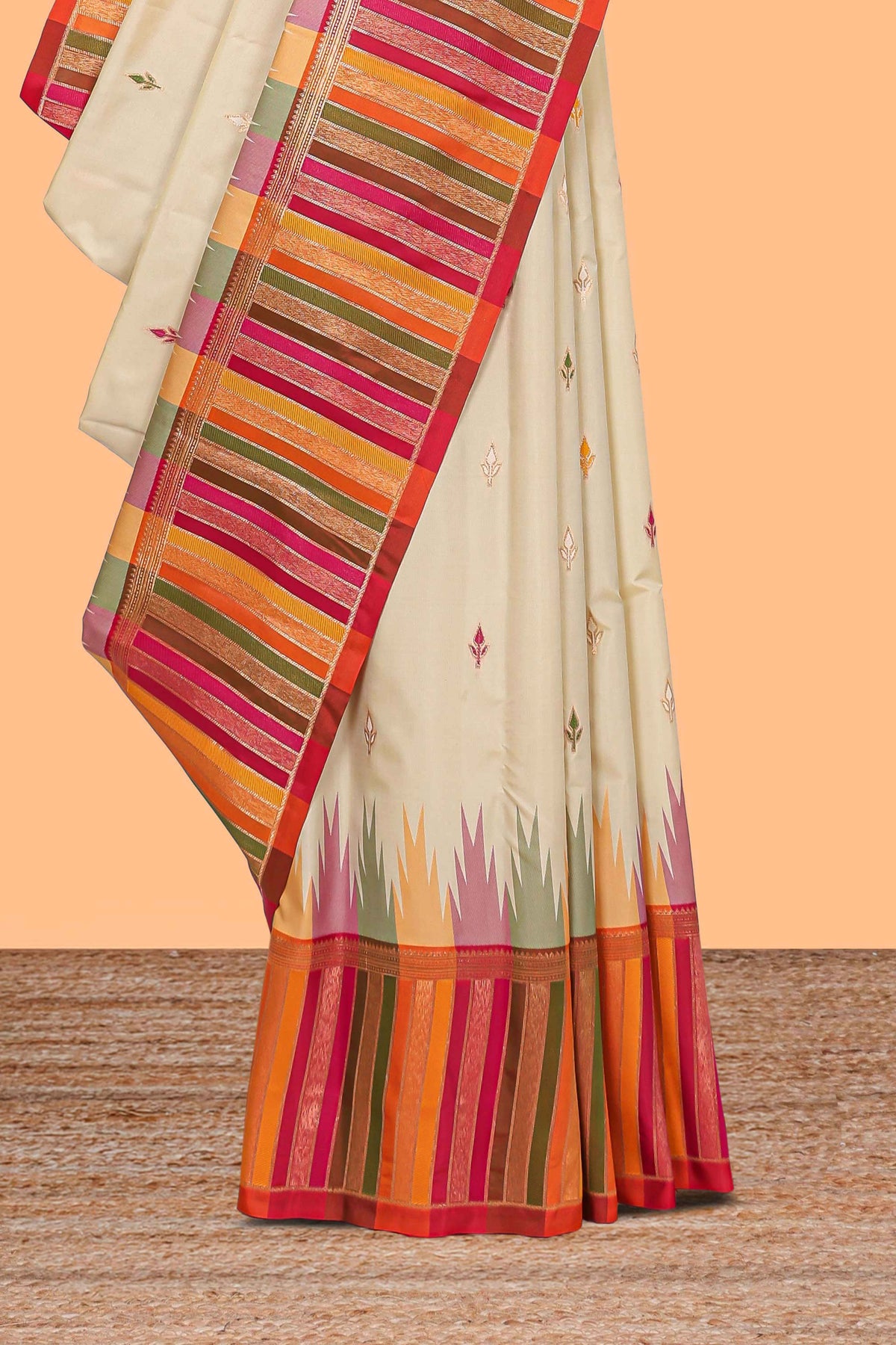 Cream floral motifs semi soft silk saree with contrast multicolor striped border and blouse