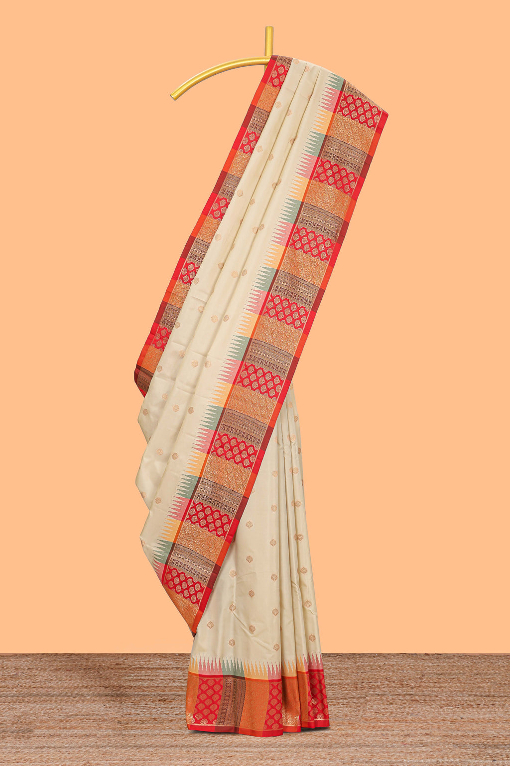 Cream zari butta designed semi soft silk saree with contrast red and gold geometric and floral pattern border and blouse
