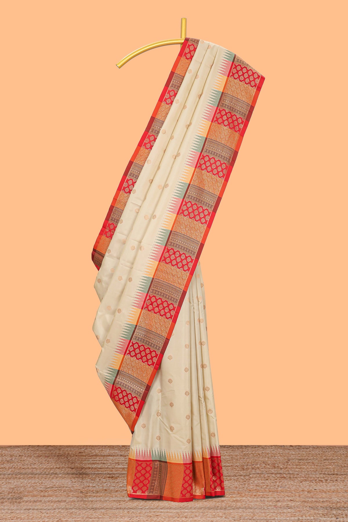 Cream zari butta designed semi soft silk saree with contrast red and gold geometric and floral pattern border and blouse