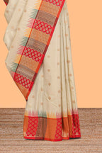 Cream zari butta designed semi soft silk saree with contrast red and gold geometric and floral pattern border and blouse