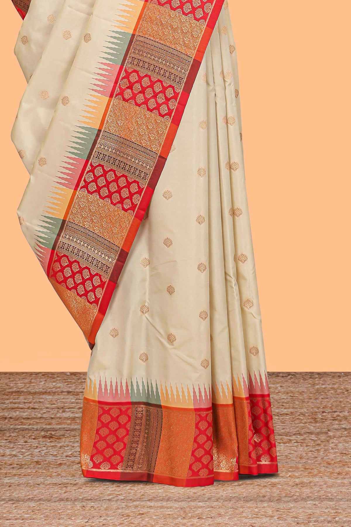 Cream zari butta designed semi soft silk saree with contrast red and gold geometric and floral pattern border and blouse