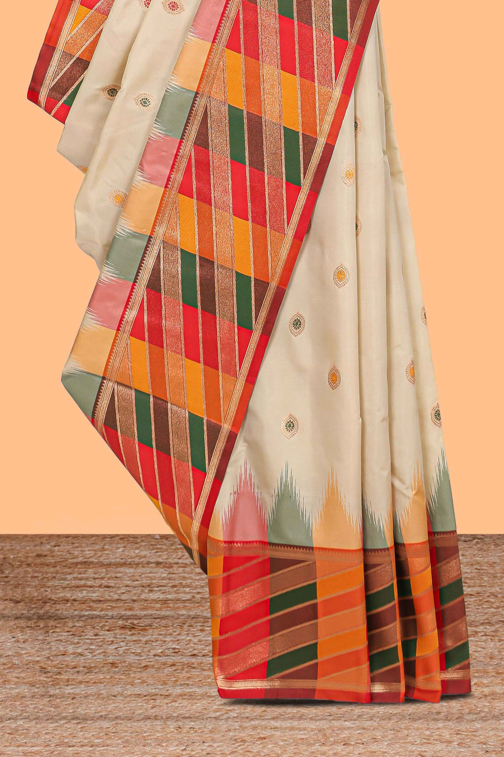 Cream butta designed semi soft silk saree with contrast multicolor geometric designed border and blouse