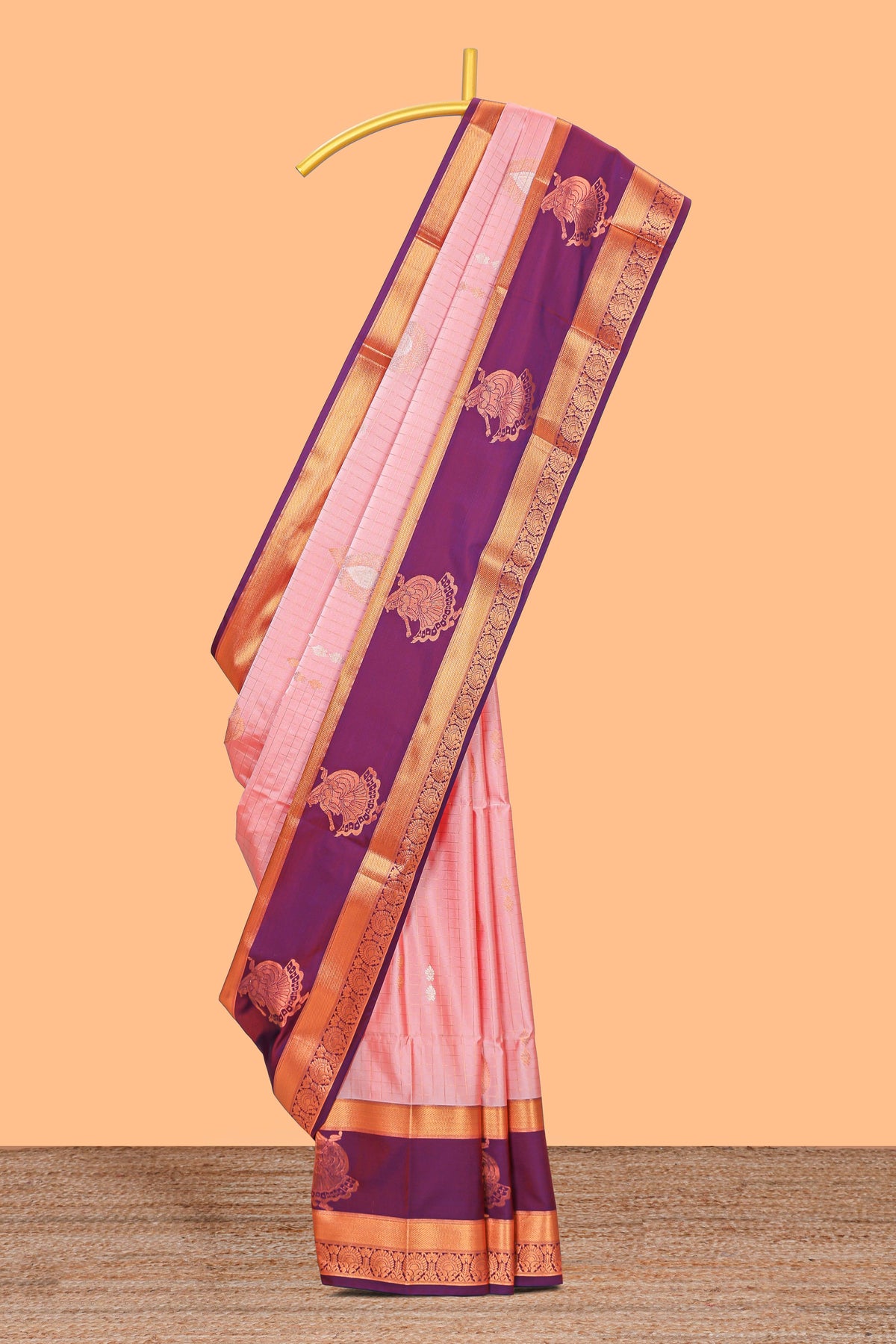 Light pink checked and floral motifs semi soft silk saree with contrast pavai motifs border and blouse