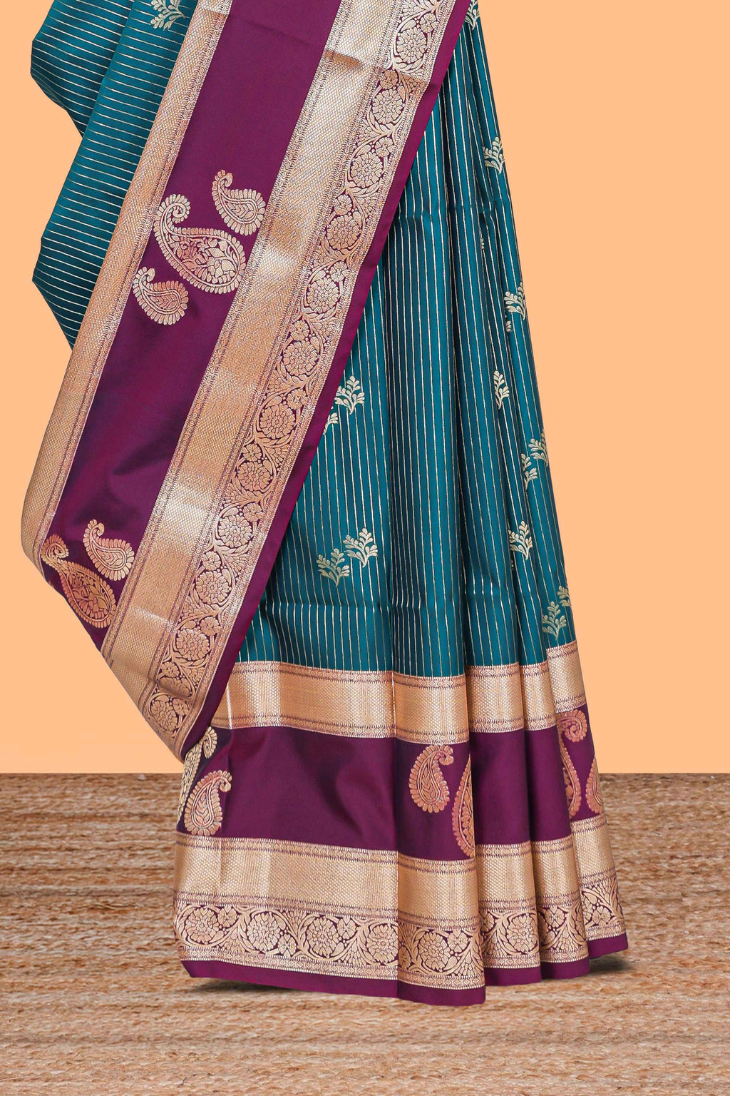 Teal-peacock blue striped and leafy motifs semi soft silk saree with contrast zari manga motifs border and blouse