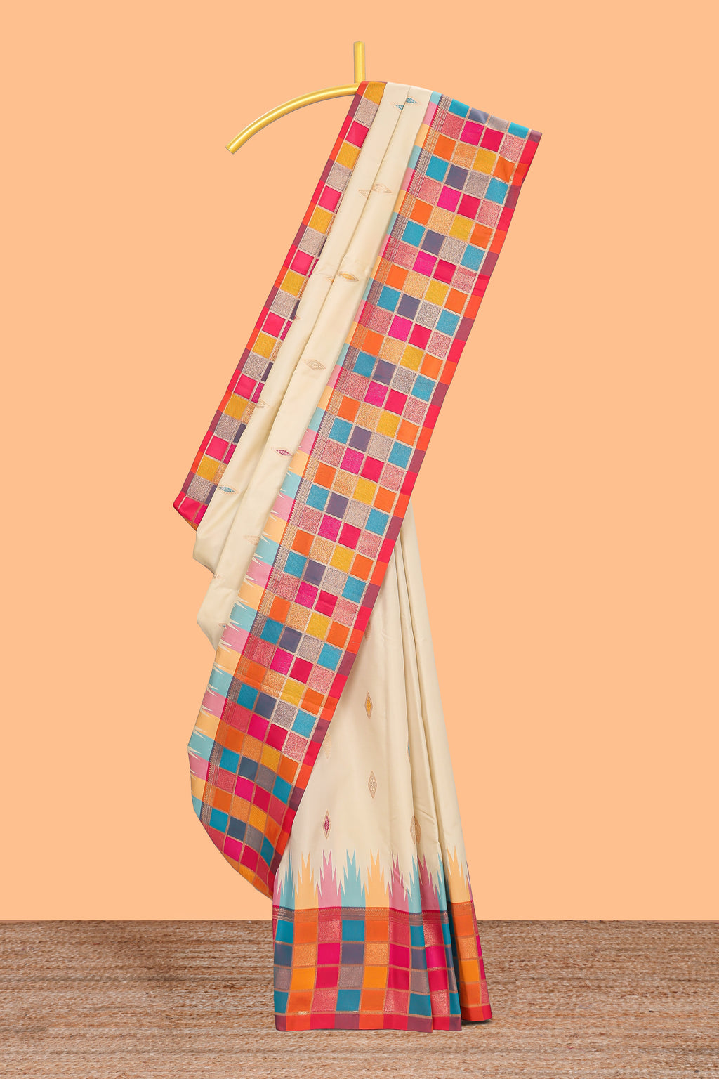 Cream geometric motifs semi soft silk saree with contrast multicolor checked border and blouse