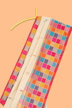 Cream geometric motifs semi soft silk saree with contrast multicolor checked border and blouse