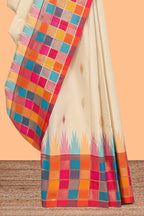 Cream geometric motifs semi soft silk saree with contrast multicolor checked border and blouse