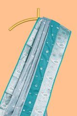 Peacock Teal Blue Tissue Silk Saree with Silver Zari Weaving and Contrast Teal Border along with Matching Blouse
