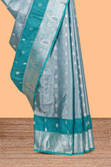 Peacock Teal Blue Tissue Silk Saree with Silver Zari Weaving and Contrast Teal Border along with Matching Blouse