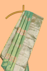 Pastel Green Tissue Silk Saree with Zari Weaving and PastelFloral Accents along with Matching Blouse
