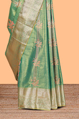 Pastel Green Tissue Silk Saree with Zari Weaving and PastelFloral Accents along with Matching Blouse