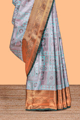 Pastel Aqua Blue Tissue Silk Saree with Antique Gold Zari Weaving and Contrast Dark Green Border along with Matching Blouse