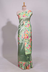 Green geometric design tissue saree with contrast floral print border and printed blouse