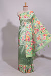 Green geometric design tissue saree with contrast floral print border and printed blouse