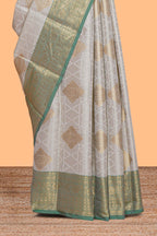 Grey zari motifs design tissue saree with contrast zari border and zari blouse