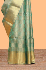 Green checked zari motifs art tissue saree with self zari border and matching blouse