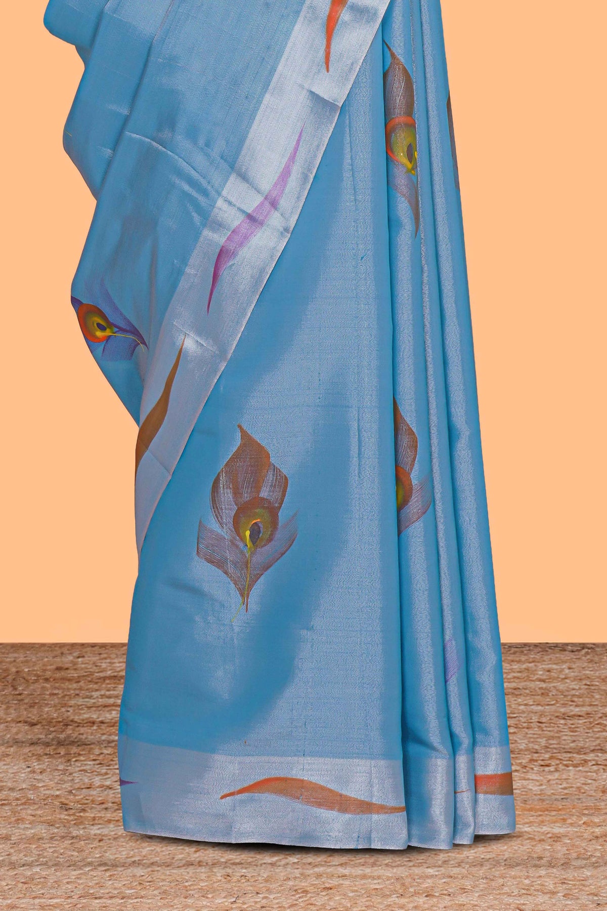 Blue peacock feather design tissue saree with self zari border and contrast blouse