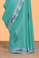 Teal green peacock feather design tissue saree with self zari border and contrast blouse