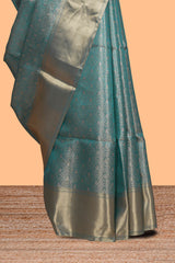 Teal blue geometric zari design art tissue saree with self zari border and matching blouse