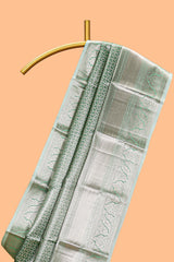 Green silver zari floral design art tissue saree with self zari border and matching blouse