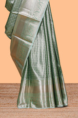 Green silver zari floral design art tissue saree with self zari border and matching blouse