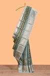 Sea green zari motifs design art tissue saree with contrast zari border and blouse