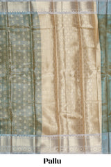 Sea green zari motifs design art tissue saree with contrast zari border and blouse