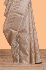 Beige chevron design art tissue saree with self zari border and matching printed blouse