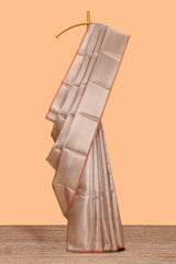 Beige geometric zari design art tissue saree with self zari border and matching blouse
