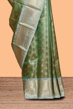 Green unique design zari motifs art tissue saree with contrast border and blouse