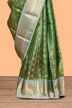 Green unique design zari motifs art tissue saree with contrast border and blouse
