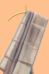 Mauve shade art tissue saree with antique gold zari border and contrast blouse