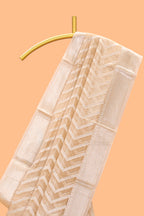 Pale peach geometric design art tissue saree with zari border and plain blouse