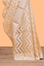 Pale peach geometric design art tissue saree with zari border and plain blouse