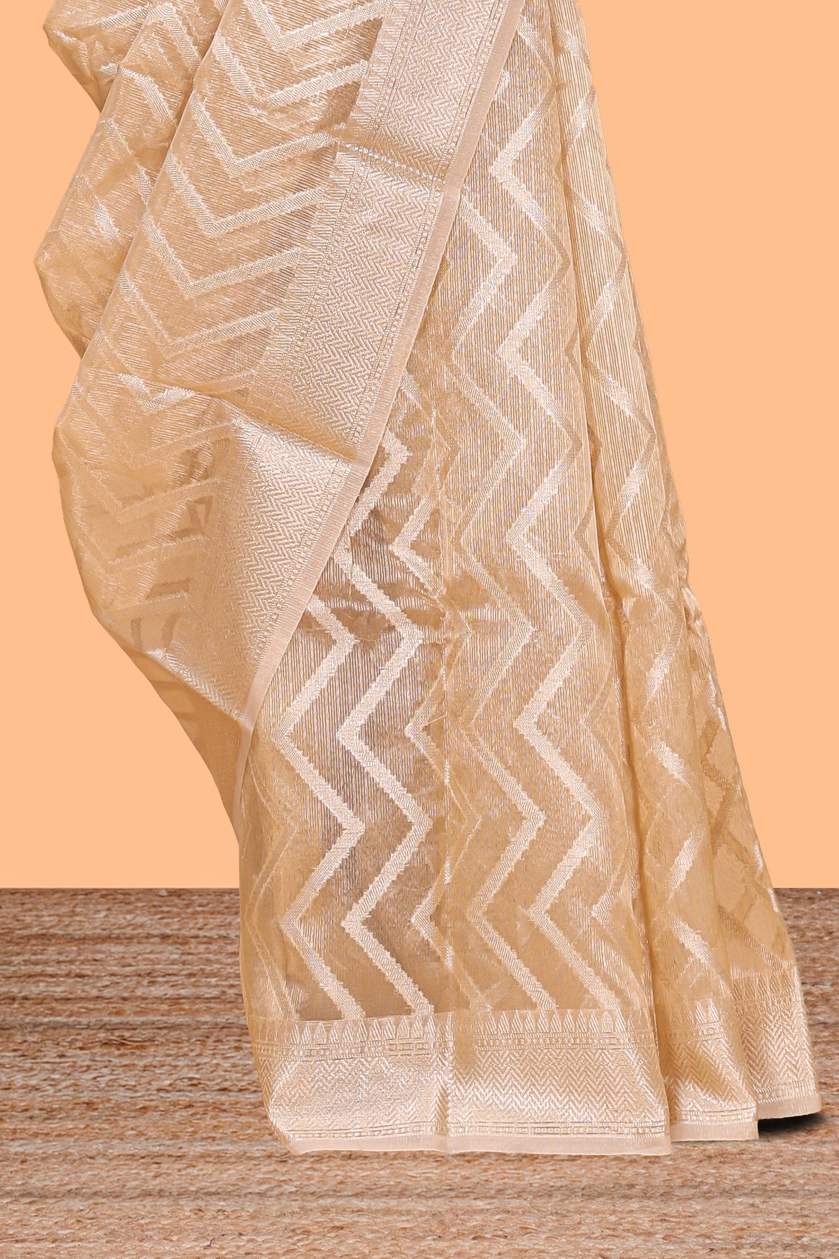 Pale peach geometric design art tissue saree with zari border and plain blouse