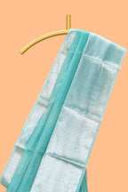 Peacock green shade plain art tissue saree with silver zari border and matching blouse